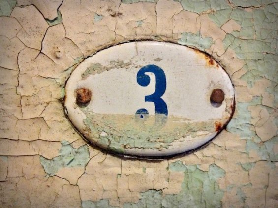 an old enamel number three sign